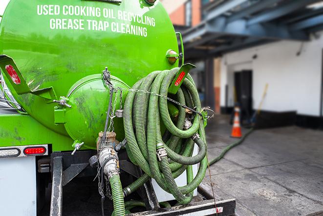 maintenance crew pumping grease trap at a fast food restaurant in Bassett